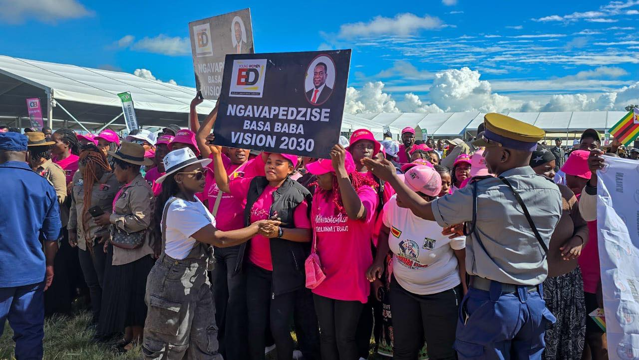 Supporters holding a Vision 2030 placard